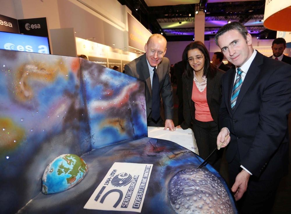 Damien English T.D. Minister for Skills, Research and Innovation with Kenza Benamar, Head of the SME unit at ESA and Barry Fennell, Enterprise Ireland celebrating ESA’s 50th birthday with a specially commissioned ‘space’ cake.